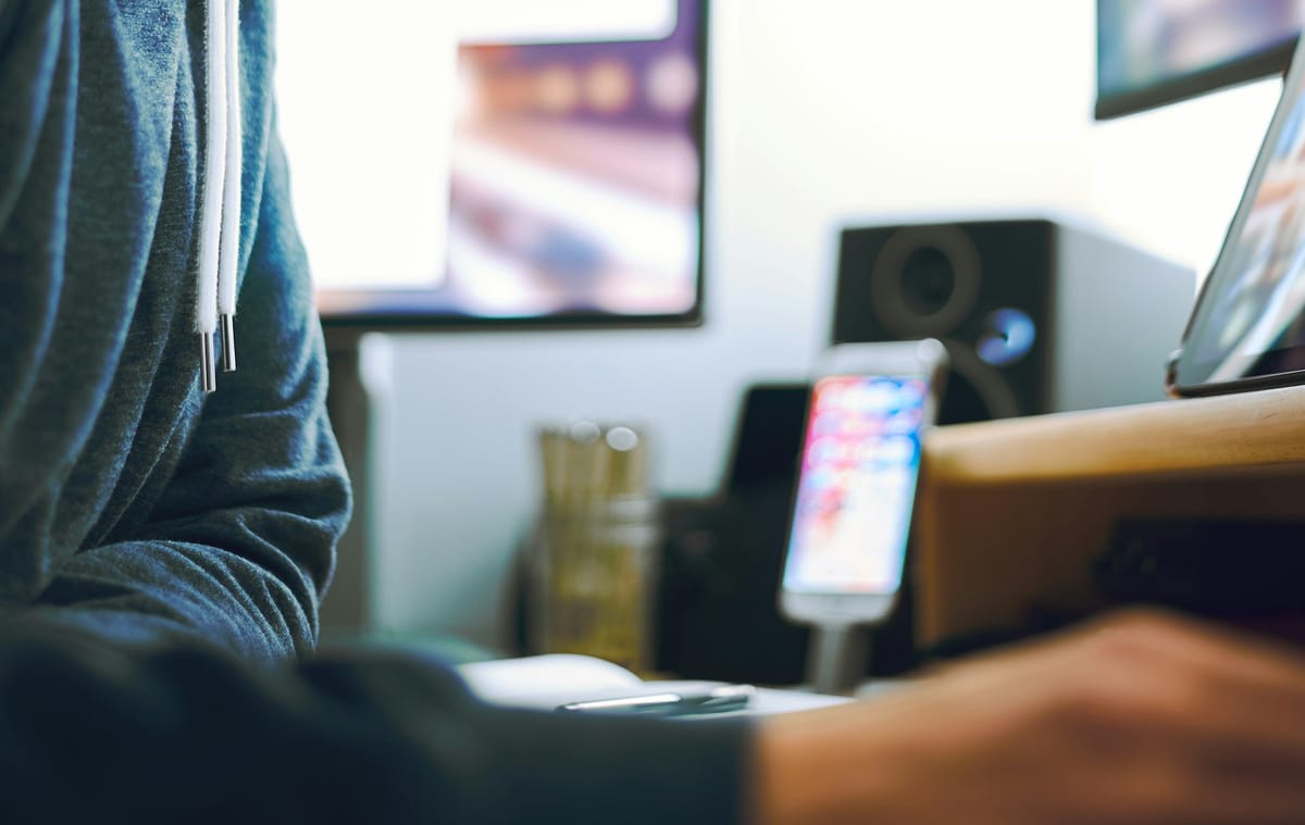 Header image of multiple screens used by a teen in a home office.